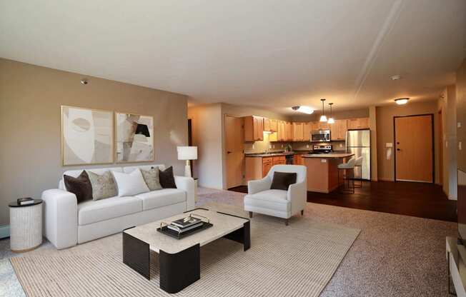 a living room with a couch and a table. Fargo, ND Urban Plains Apartments