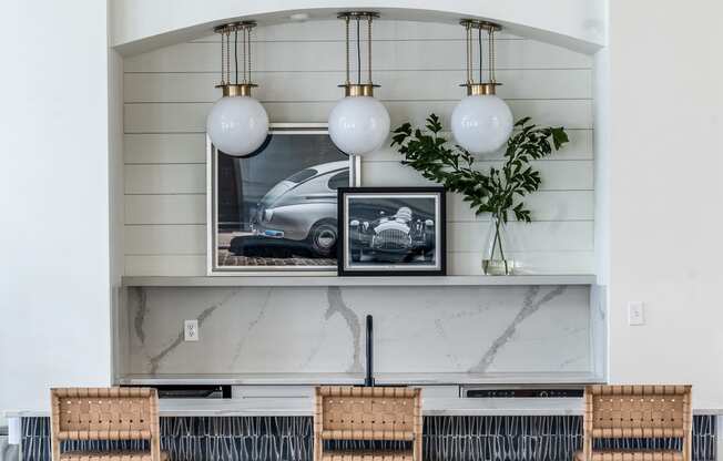 a bartop with four chairs and framed pictures  of cars in Indianapolis