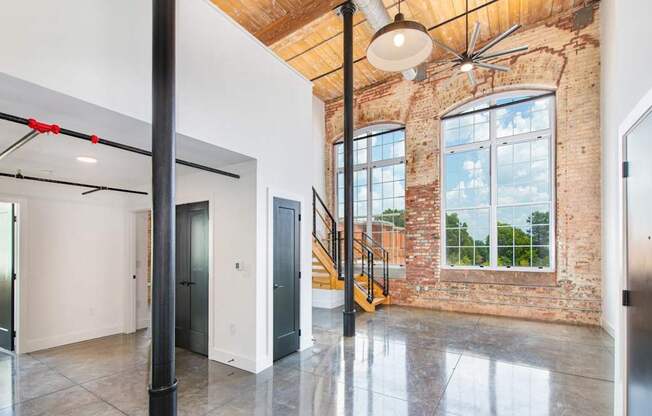 A large open space with a brick wall and a staircase.