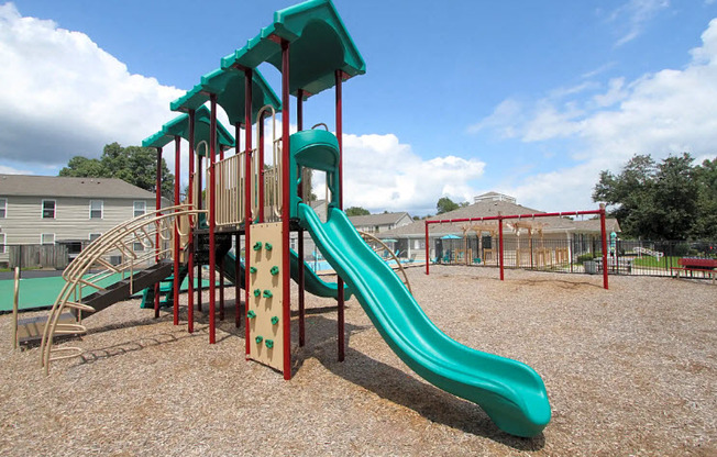 a playground with a slide at a park