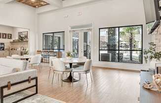 A modern dining room with a glass door leading to a balcony.