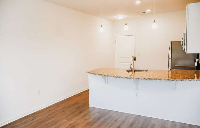 a kitchen with a counter top and a refrigerator