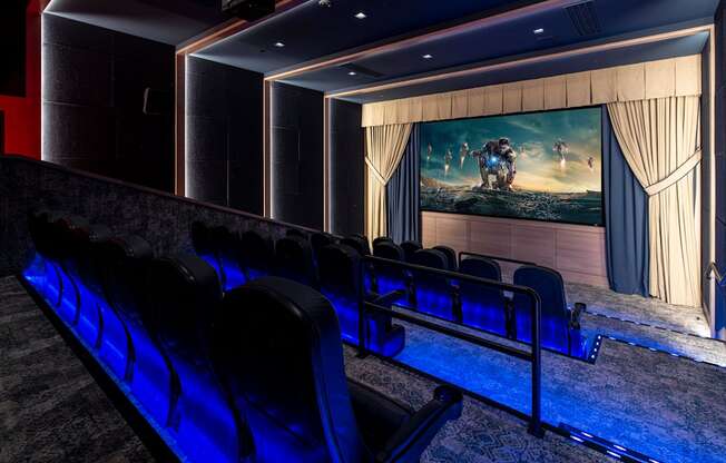 a cinema room with chairs and a large screen