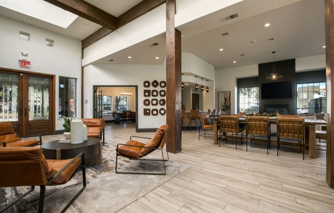 the lobby of a clubhouse with tables and chairs