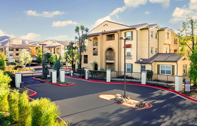 an outdoor basketball court with apartments in the background