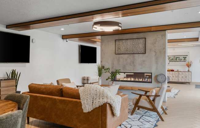a living room with a couch and chairs and a fireplace