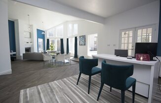 a view of a living room with a desk and chairs