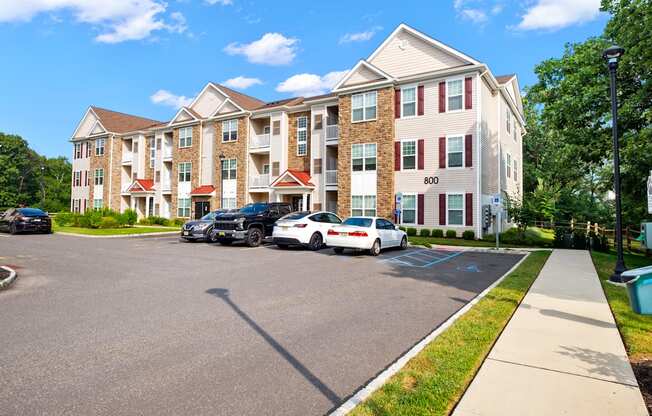 a large apartment building with cars parked in front of it
