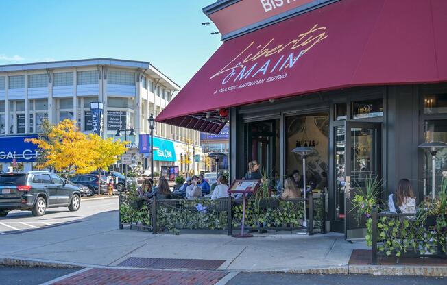Patio dining at Legacy Place brings neighborhood favorites, outdoor seating, and lively local energy just minutes from The Avens at Dedham.