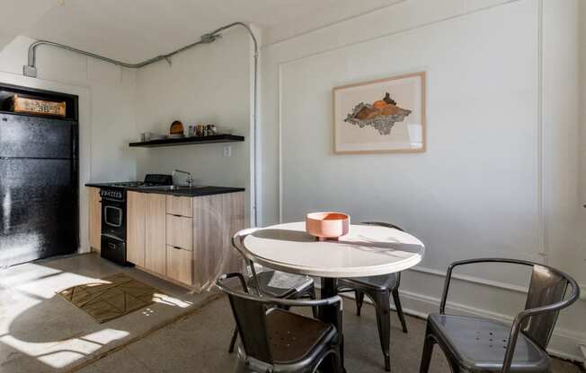 a small kitchen and dining room with a table and chairs