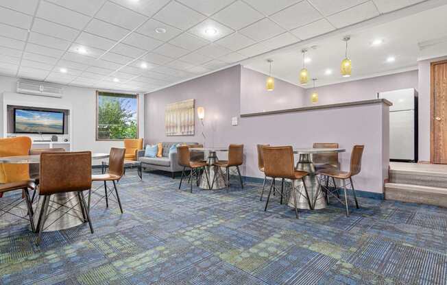 A room with a blue carpet and chairs.