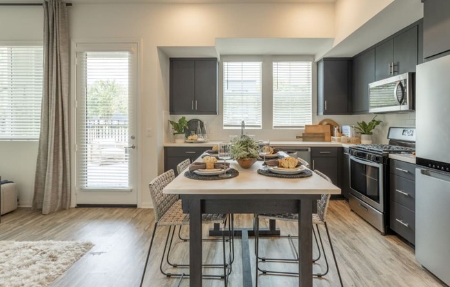 an open kitchen and dining room with a table and chairs