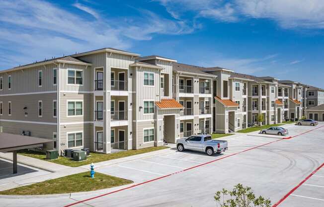 an apartment building with a car parked in a parking lot
