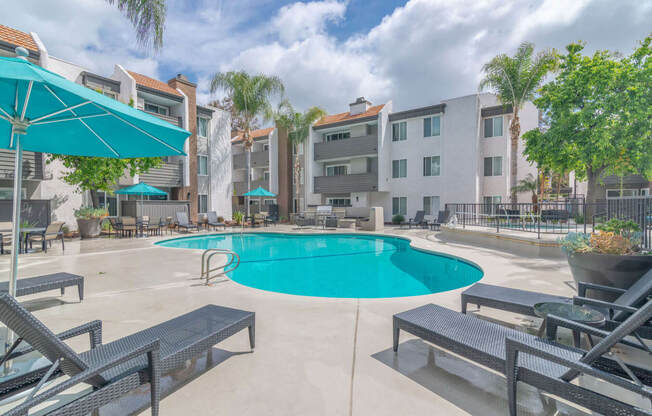 our apartments have a large swimming pool and lounge areas with umbrellas at City View Apartments at Warner Center, Woodland Hills, CA