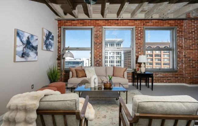 a living room with a couch and a brick wall