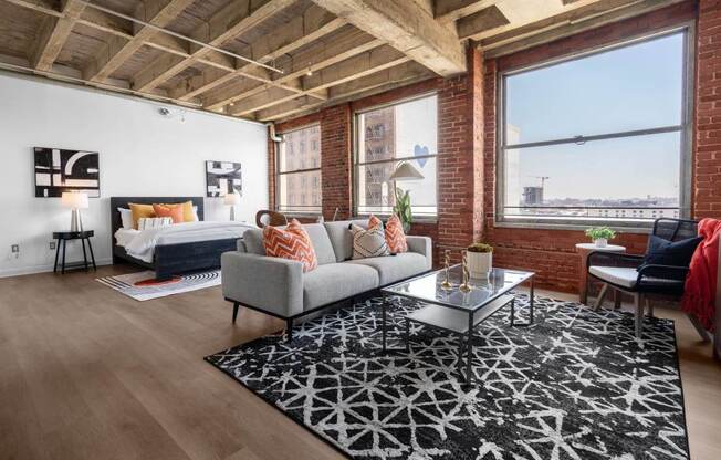 a living room with a couch and a bed in a loft