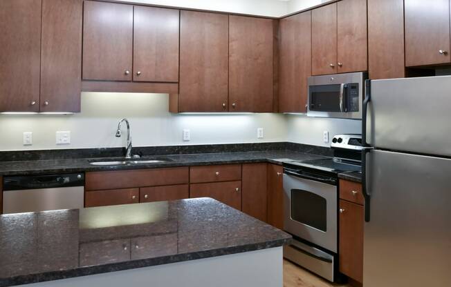 traditional kitchen with cherry cabinets and dark granite countertop