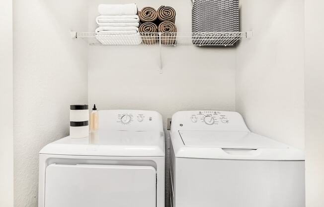 Virtually staged laundry area with shelf, towels, and basket