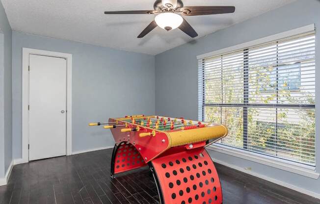A room with a red chair and a yellow xylophone.