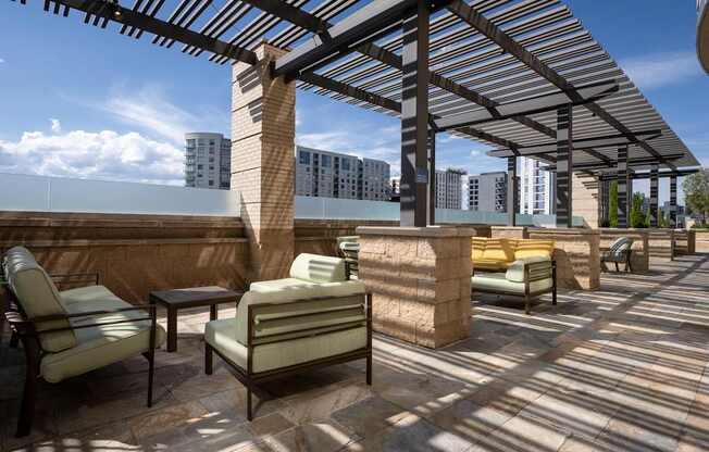 A patio with a table and chairs under a roof.