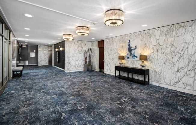 A hallway with marble walls and a statue on the wall.