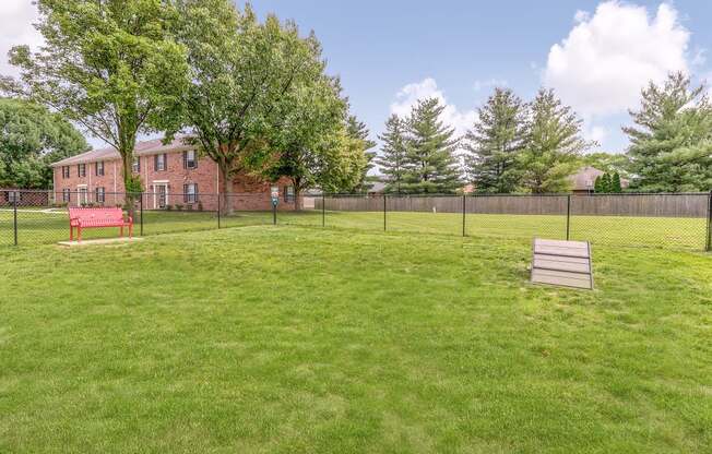 Dog park with bench seating at Ashley Pointe Apartments