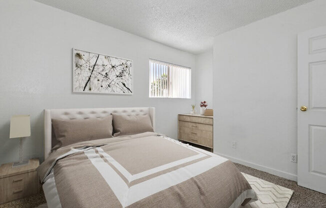 Model Bedroom with Carpet and Window at District at Fiesta Park Apartments located in Mesa, AZ.