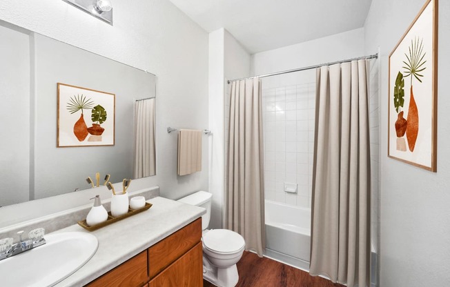 bathroom with hardwood-style flooring and wood cabinetry