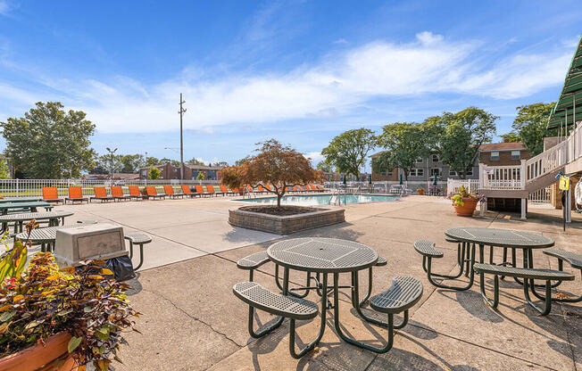 A sunny day at the park with picnic tables and benches.