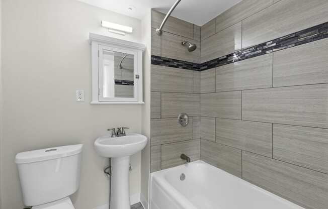 Bathroom with Wide Tiled Shower and Above Sink Mirror at Stockbridge Apartment Homes, Seattle