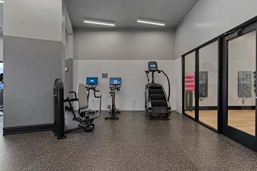 a gym with weights and cardio equipment in a building at SevenO2 Main Apartments, Salt Lake City, UT