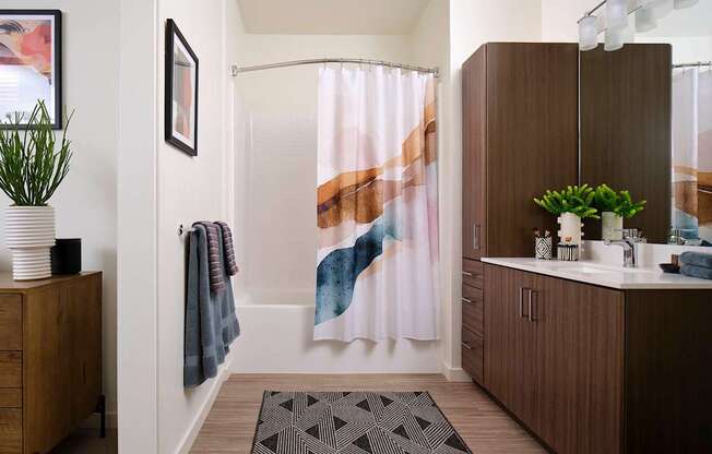 a bathroom with a shower and a sink in it