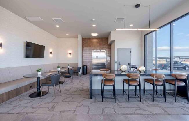 A modern dining area with a long table and chairs.