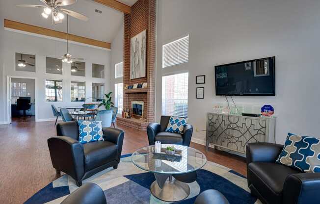 a living room with couches and a table and a television