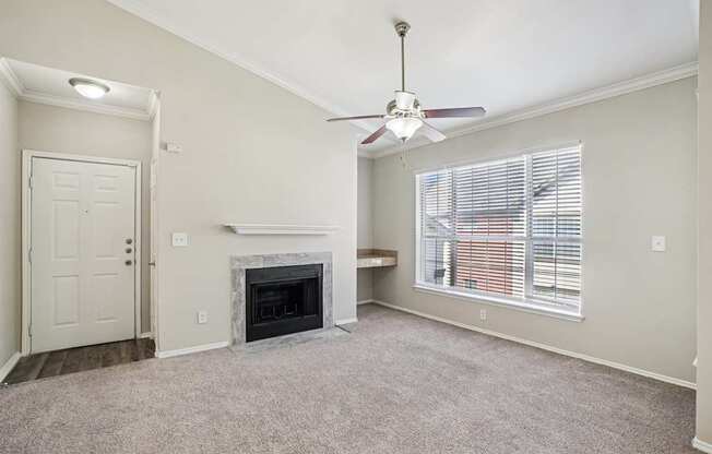 A room with a fireplace and a ceiling fan.
