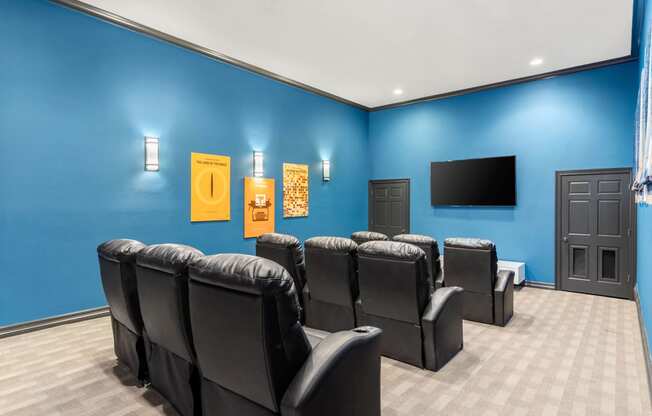 our theater room with a blue wall and chairs at Villages of Cypress Creek, Houston