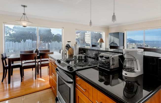 a kitchen with a stove top oven next to a window