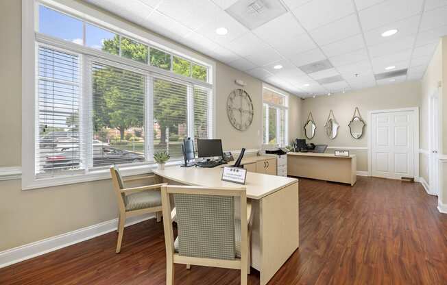 an office with a desk and a large window