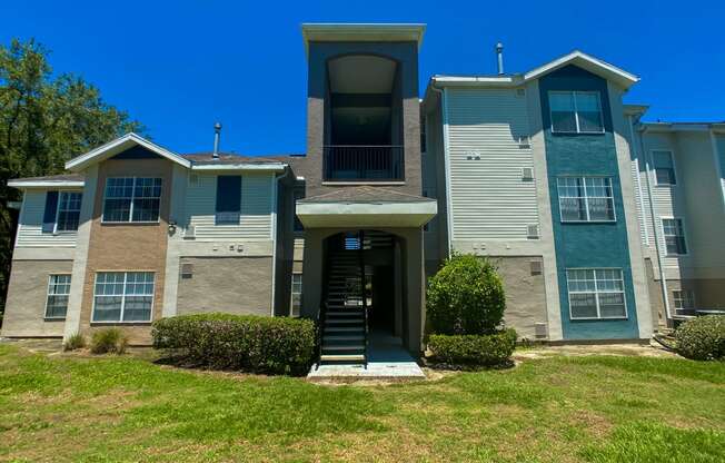 Apartment building exterior surrounded by native landscaping