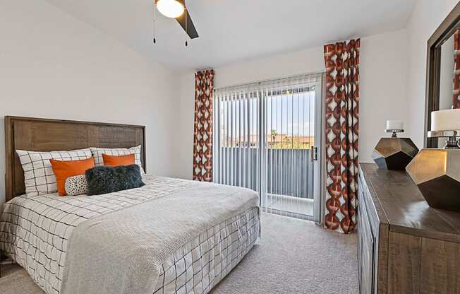 A bedroom with a large bed and a ceiling fan.
