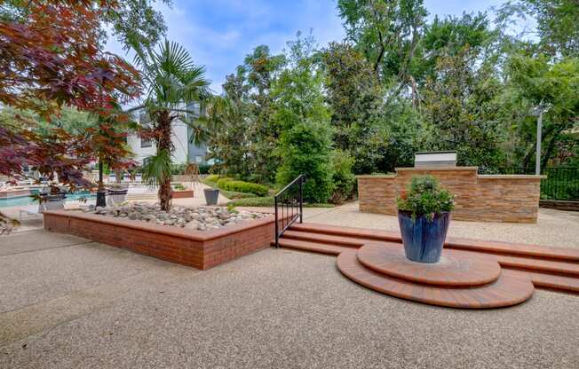 a fenced in area with stairs and a fountain