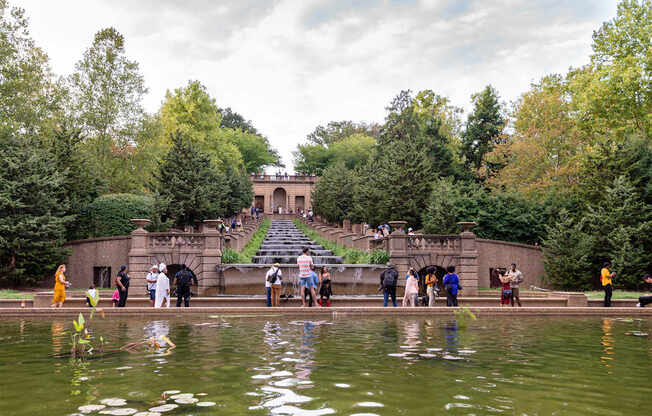 A group of people are standing on a bridge over a body of water.