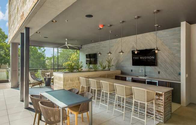 a bar with chairs and a table in front of a window