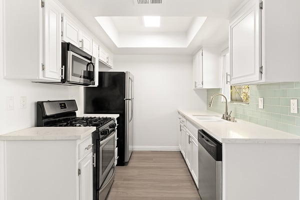 a white kitchen with a stove and a refrigerator at NOHO GALLERY Apartments, North Hollywood , California