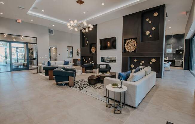 Spacious clubhouse with high ceiling, lots of cozy seating, and fireplace