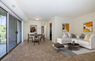 A modern living room with a dining table and a white couch.