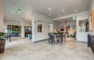 Clubhouse with a dining area and a bar with chairs and tables at The Atlantic Highland Park, Texas