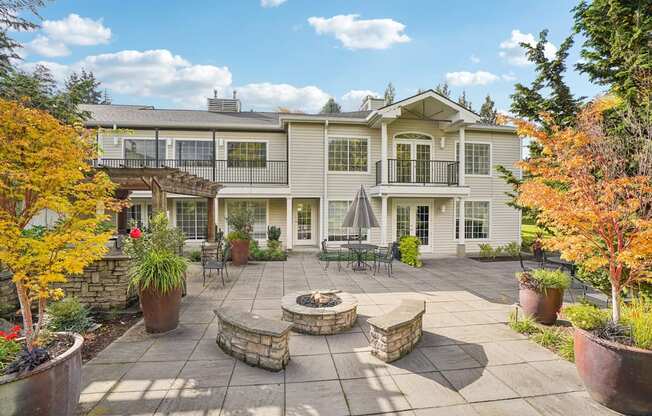 An apartment courtyard with a patio and a fire pit.