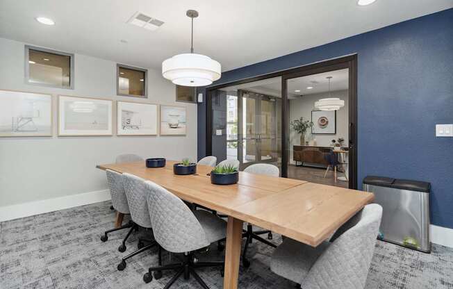 A conference room with a long table and chairs at The Kitt at Warner Center Apartments, California