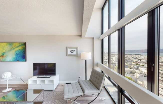 a living room filled with furniture and a large window